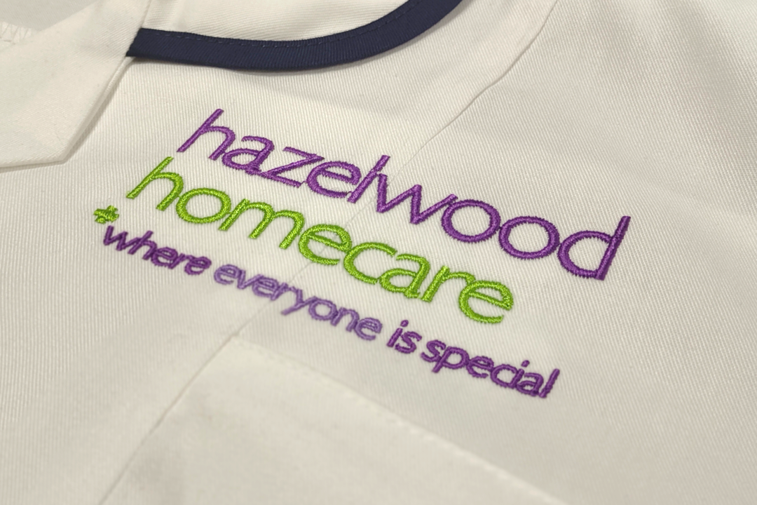 A photograph showcasing an embroidered tunic for Hazelwood Homecare.