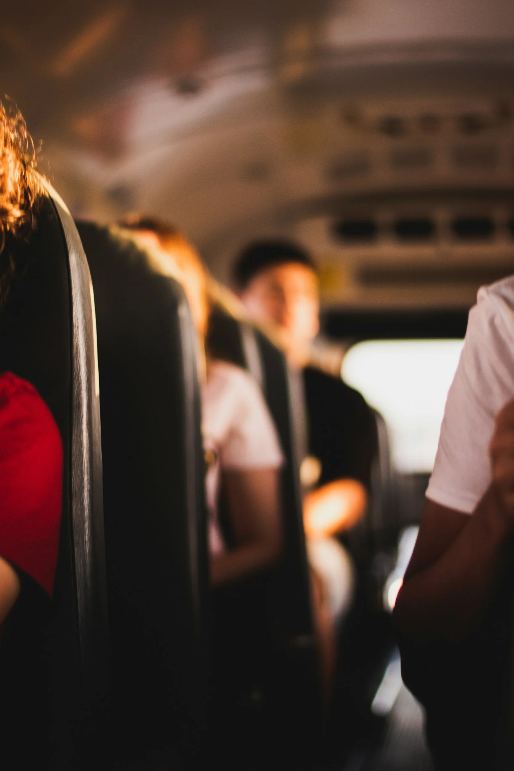 Image shows blurred inside of a school bus with children sitting in each row.