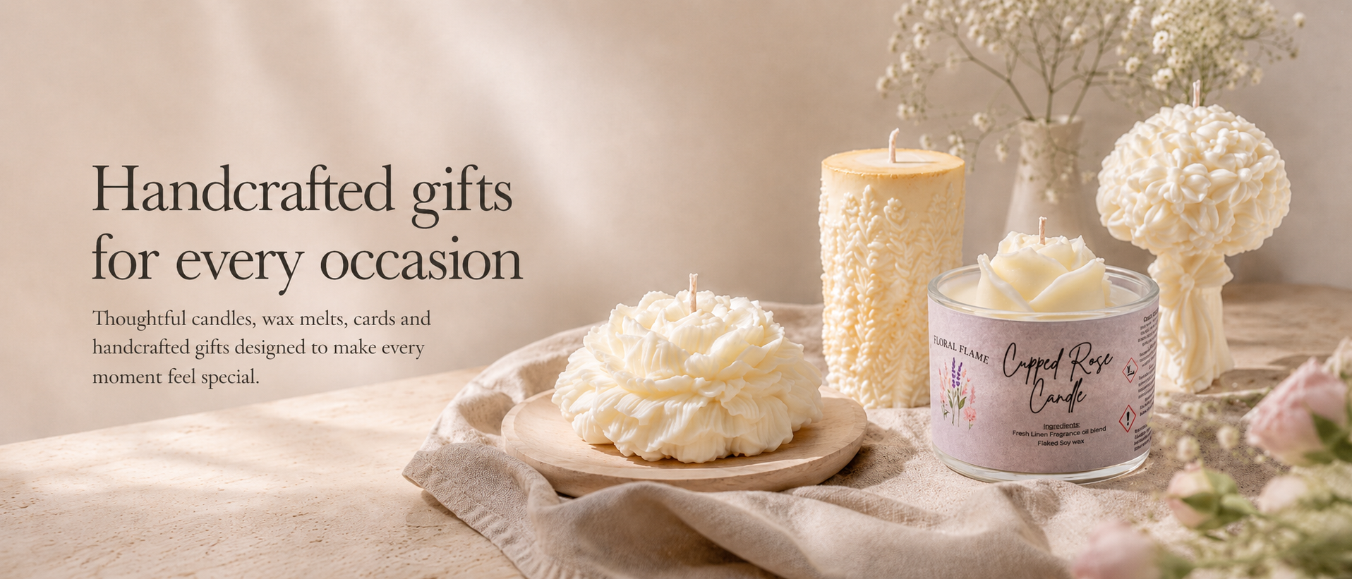 Display of handcrafted candles and floral arrangements on a wooden surface with text promoting gift ideas for various occasions.