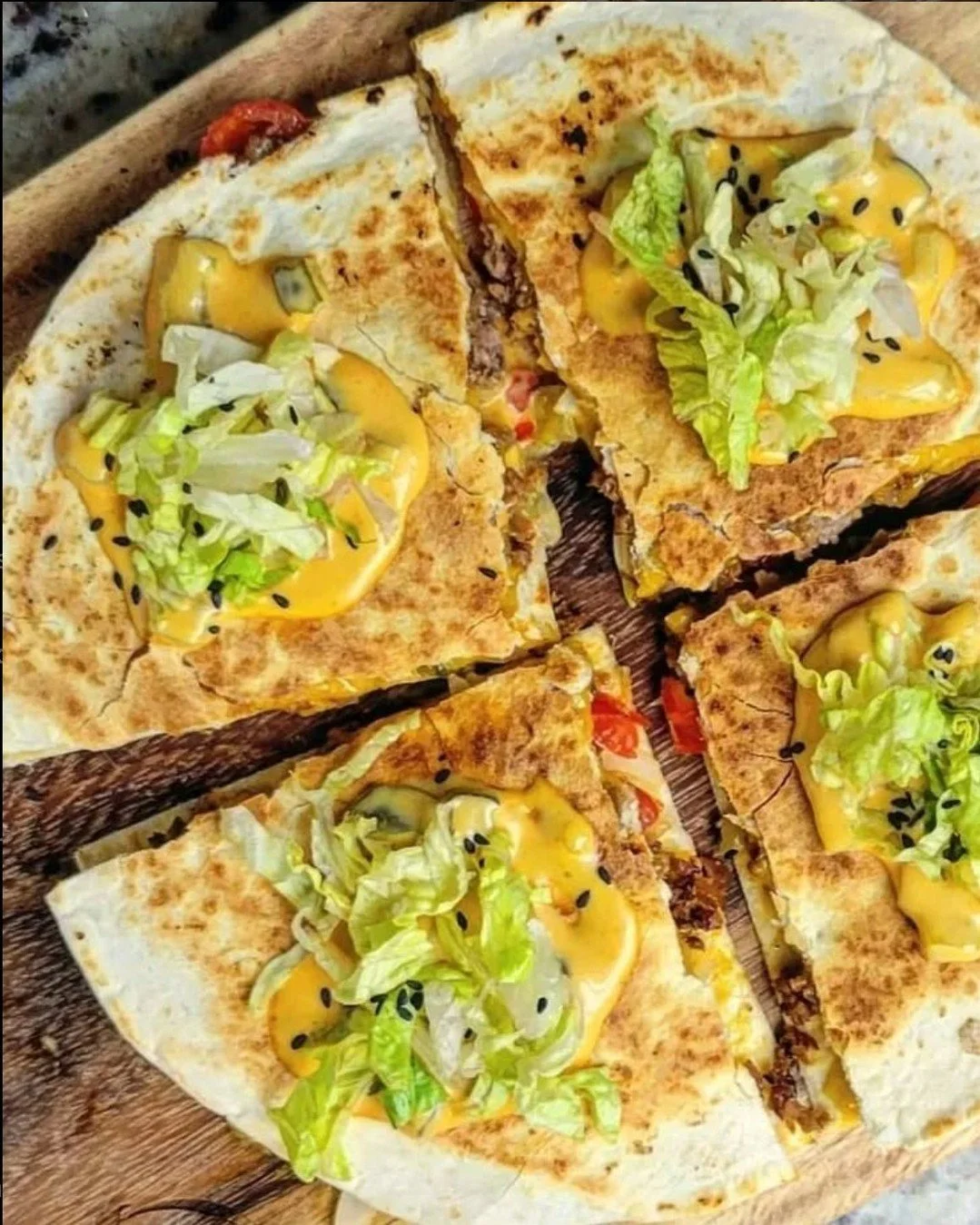 Have you ever tried Burger Quesadillas? It's everything you love about a big, sloppy, burger...all packed unto a crispy quesadilla!
My trick, when making griddled dishes like this and using vegan cheese is to let the microwave do the heavy lifting.