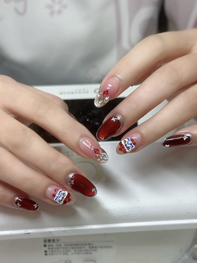 Iris nail art at Serene Nail Club NYC: Red holiday nails with glitter
