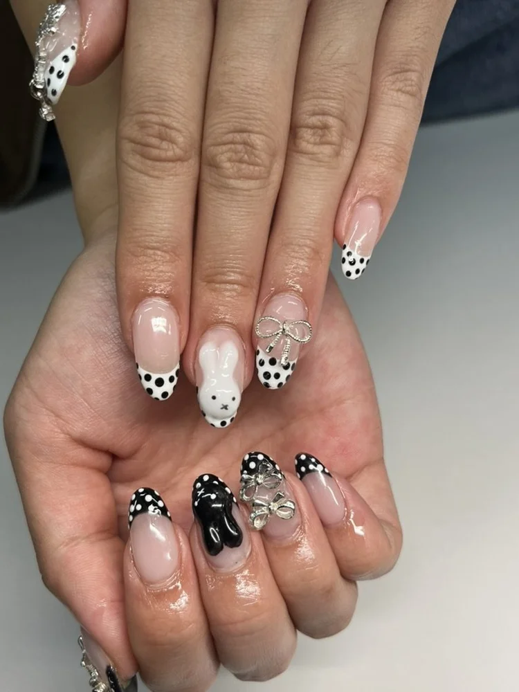 Cecilian nail art at Serene Nail Club NYC: Black and white polka dots with bow charms
