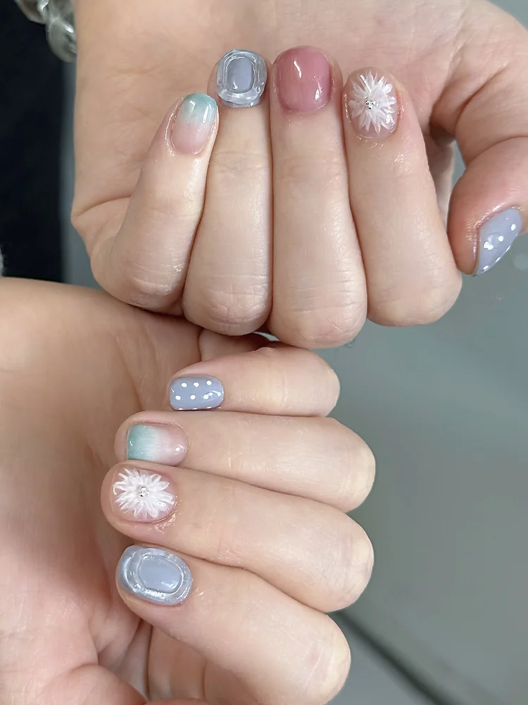 Iris nail art: Pastel florals with a white flower and rhinestone center