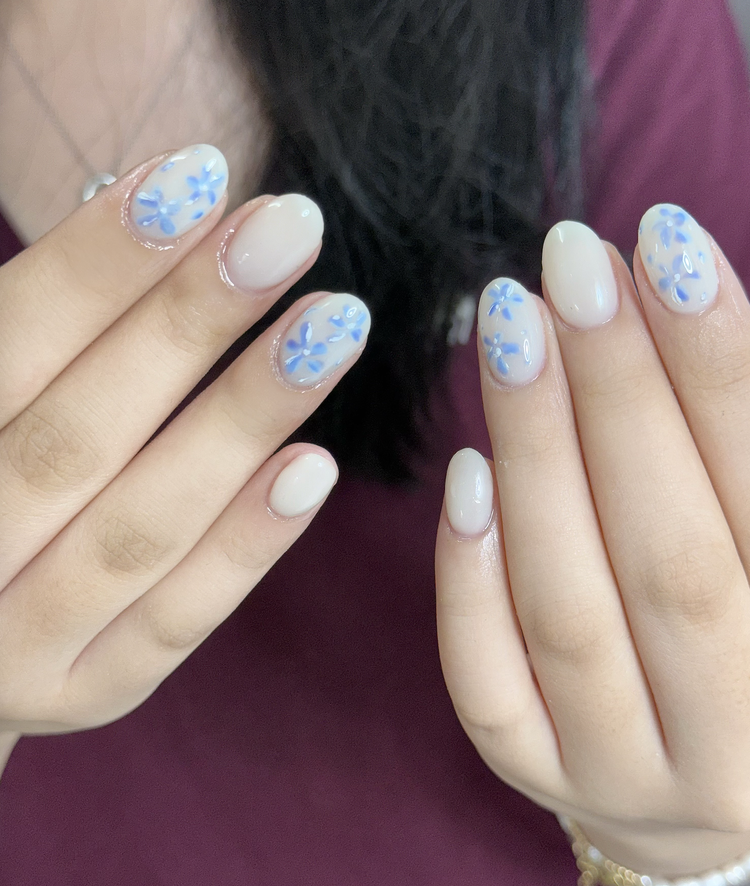 Iris nail art at Serene Nail Club NYC: White base with blue florals