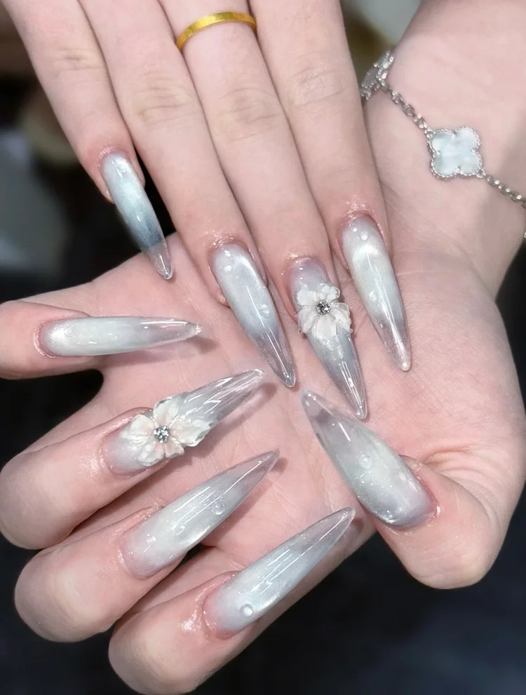 Iris nail art at Serene Nail Club NYC: Iridescent white marble almond nails with 3D flowers and rhinestones