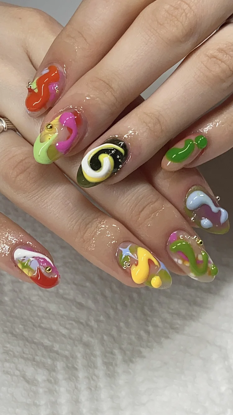 Alexis nail art at Serene Nail Club NYC: Bright colorful swirls decorated with small gold beads