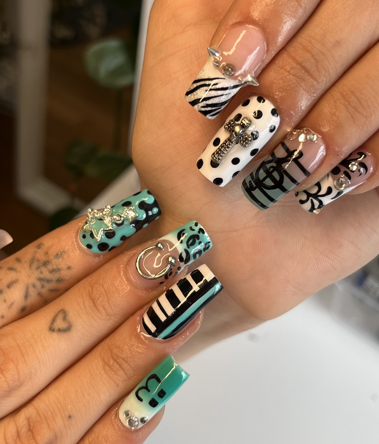 Natalie nail art at Serene Nail Club NYC: Black and white patterns with rhinestones and 3D metallic charms