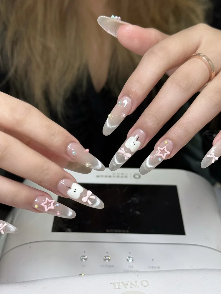 Iris nail art at Serene Nail Club NYC: Long nails with stars, bows and a bunny design