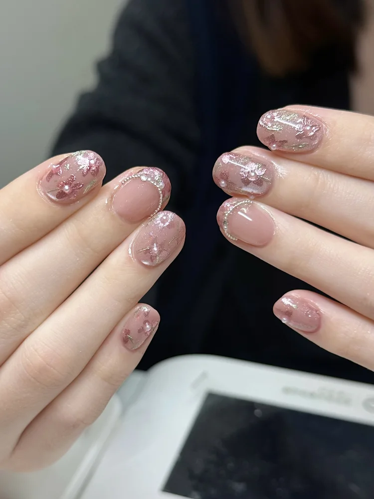 Iris nail art at Serene Nail Club NYC: Pink and gold florals with pearl accents