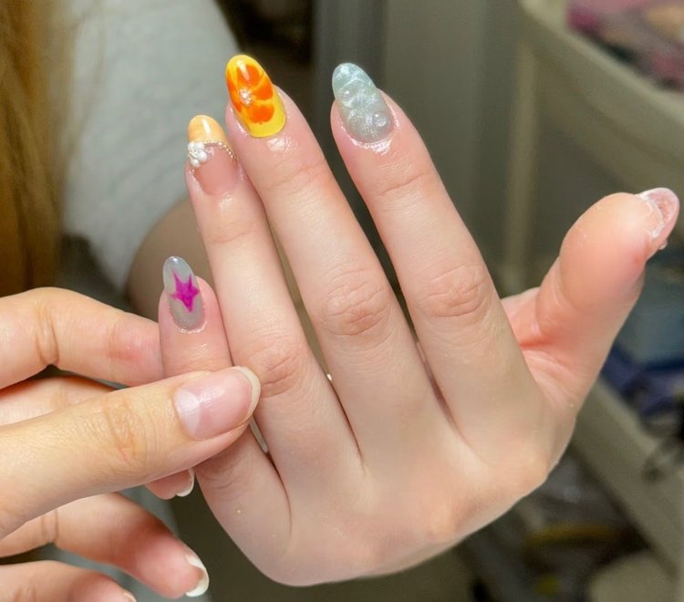 Iris nail art at Serene Nail Club NYC: Colorful nail art with gems and patterns