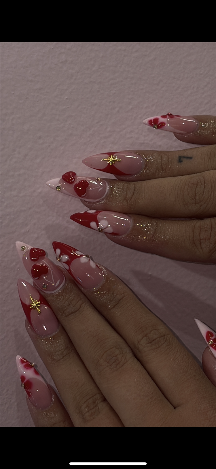 Reina nail art at Serene Nail Club NYC: Pink and red with gold, pearl and heart embellishments