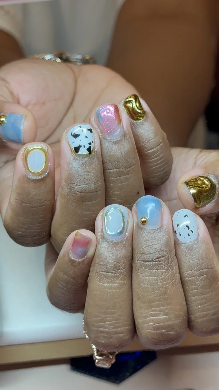 Alexis nail art at Serene Nail Club NYC: Gold, blue, marbled pink and cow print designs