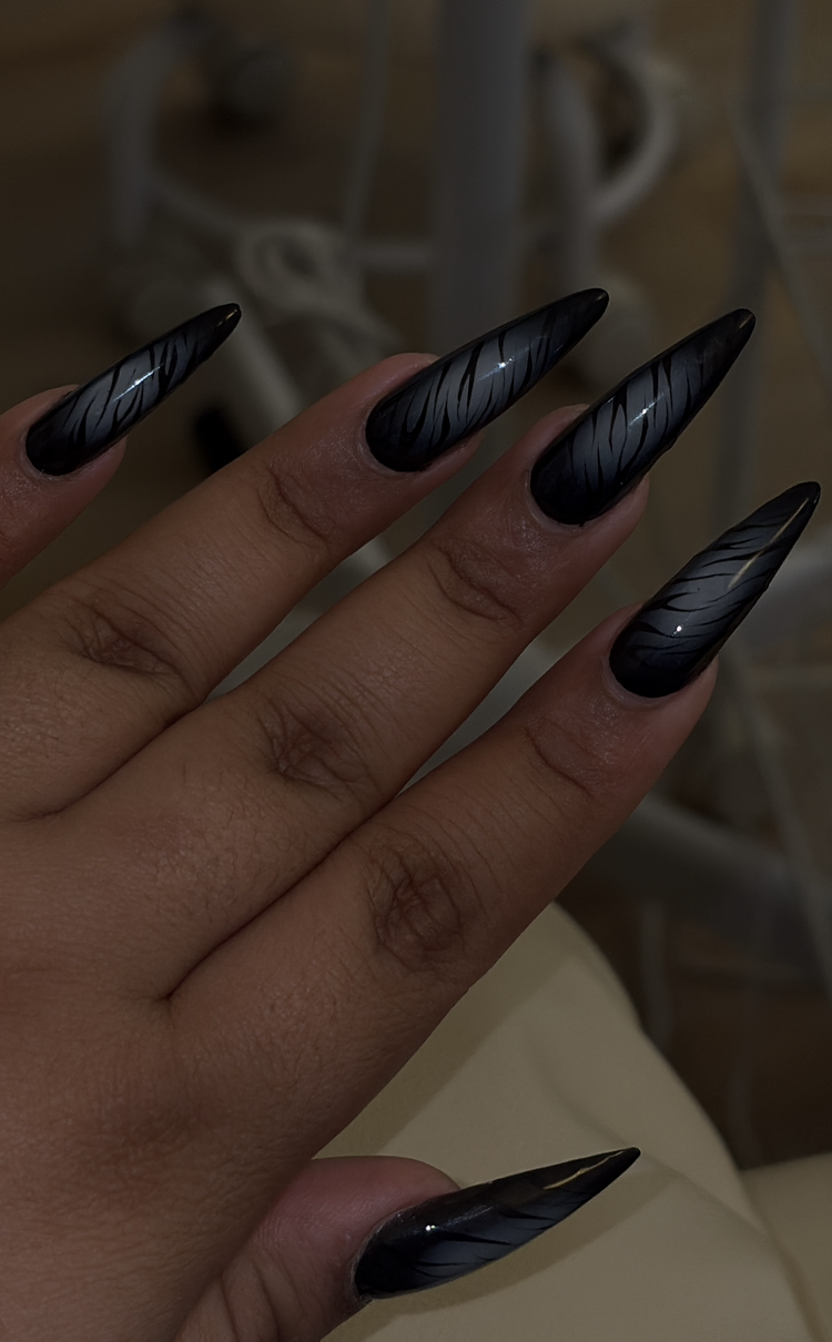 Reina nail art at Serene Nail Club NYC: Long glossy black nails with a feather design