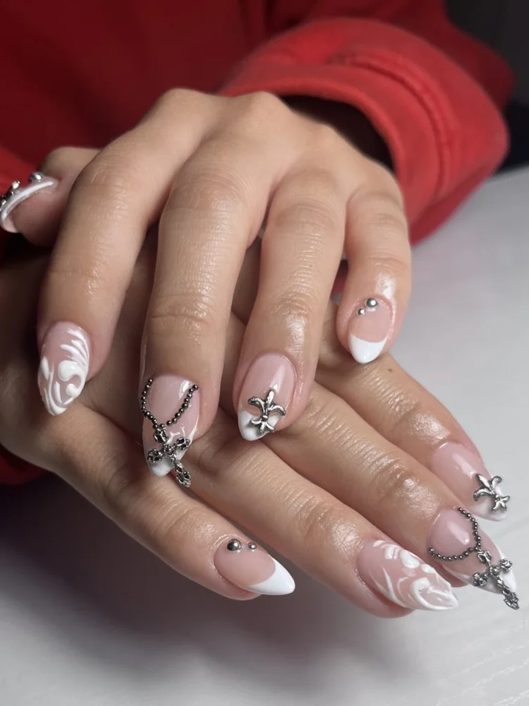 Cecilian nail art at Serene Nail Club NYC: White and pink designs with rhinestones and a bow charm