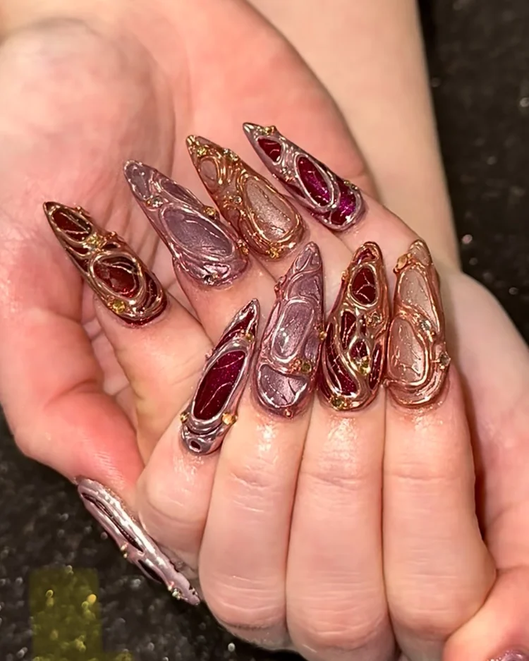 Reina nail art at Serene Nail Club NYC: Deep red, pink and metallic swirls with gold