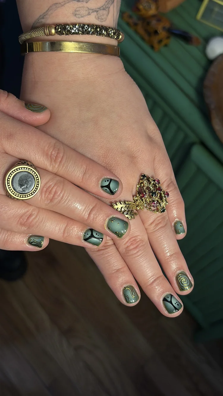 Reina nail art at Serene Nail Club NYC: Green, black and gold designs