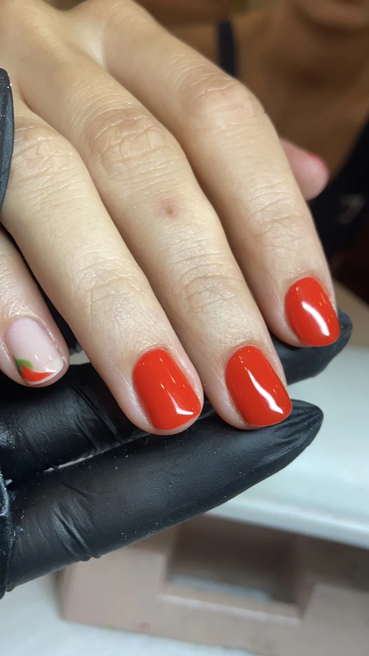 Alexis nail art at Serene Nail Club NYC: Red nails with a tiny floral detail on the thumb