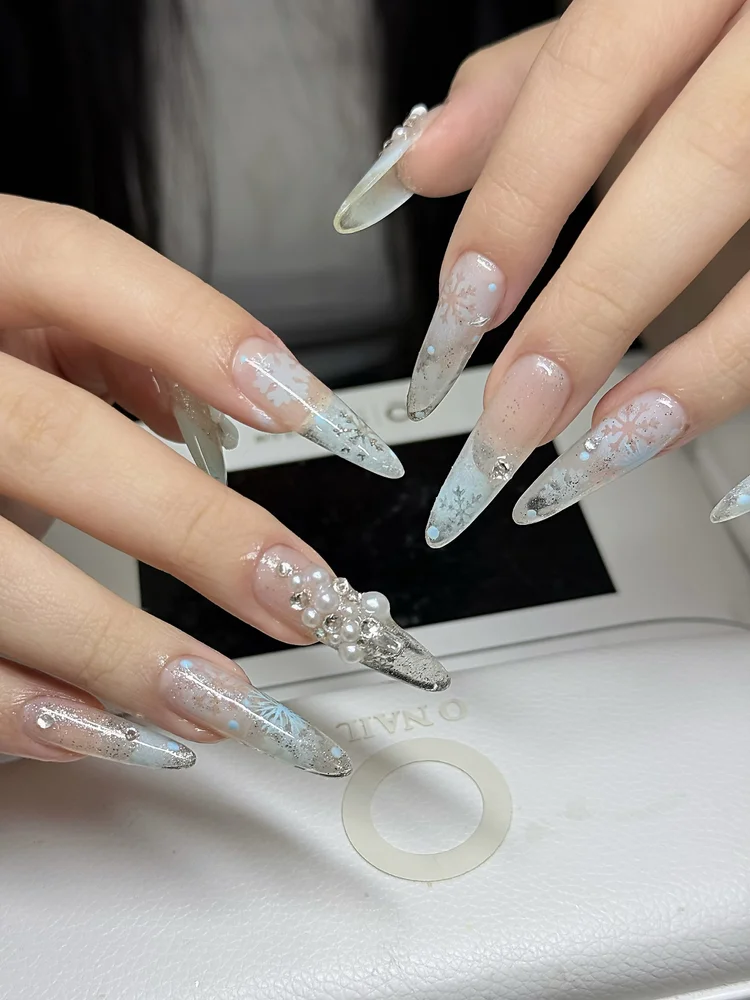 Iris nail art at Serene Nail Club NYC: Snowflake designs with small rhinestones