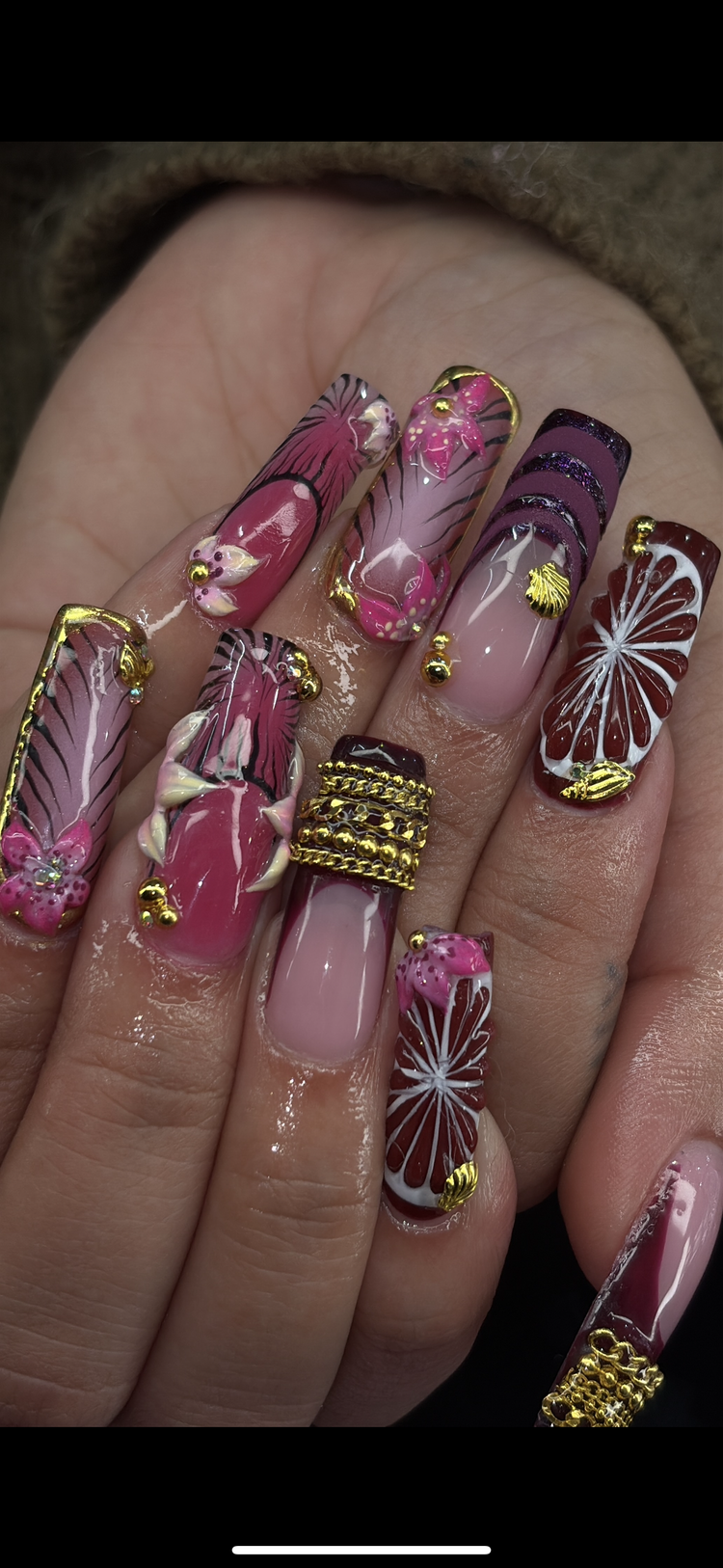 Reina nail art at Serene Nail Club NYC: Pink, red and purple florals and butterflies with gold
