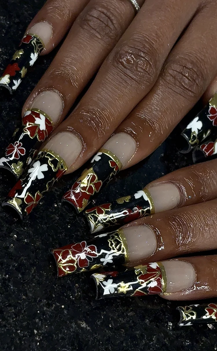 Reina nail art at Serene Nail Club NYC: Red, white and black florals with gold accents