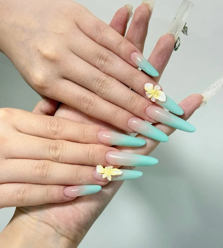 Iris nail art at Serene Nail Club NYC: Turquoise ombre with small white and yellow flowers