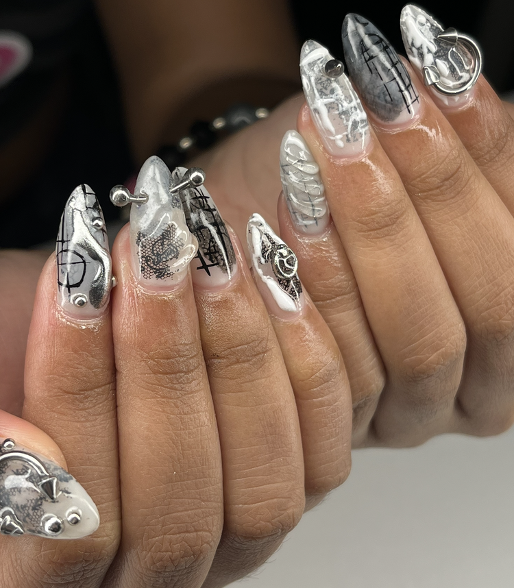 Natalie nail art at Serene Nail Club NYC: White and black marble with line art and a nail charm