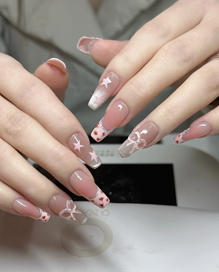 Iris nail art at Serene Nail Club NYC: Pink and white stars with silver accents
