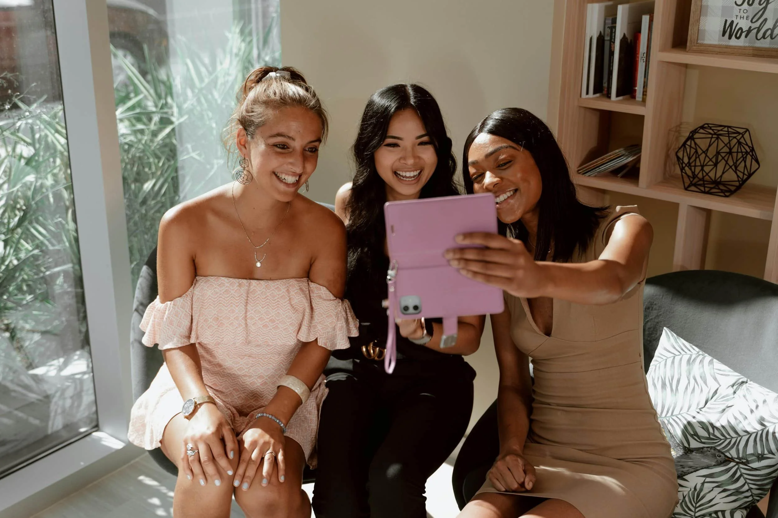 Women taking a picture and smiling, reflecting self-esteem and confidence.