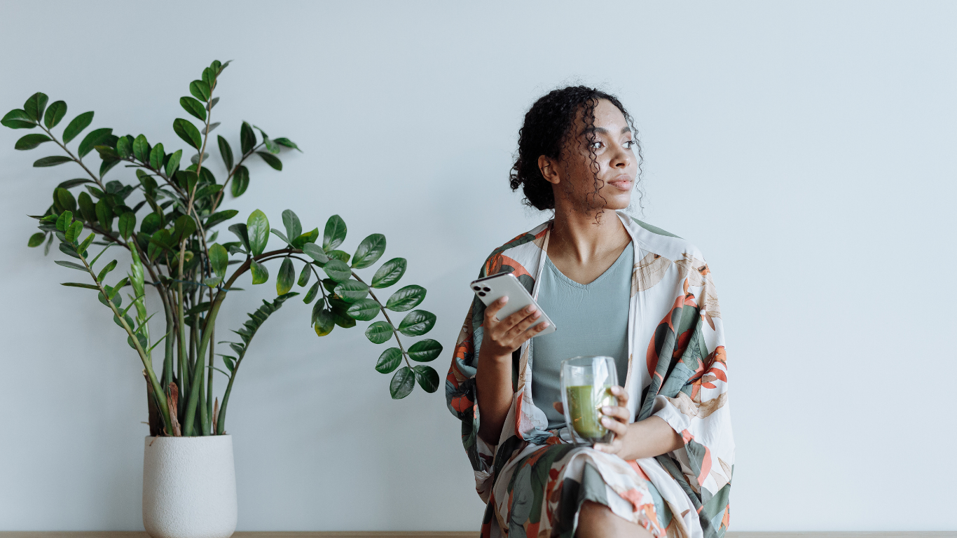 Woman relaxing and looking out the window during a quiet moment of reflection and emotional healing