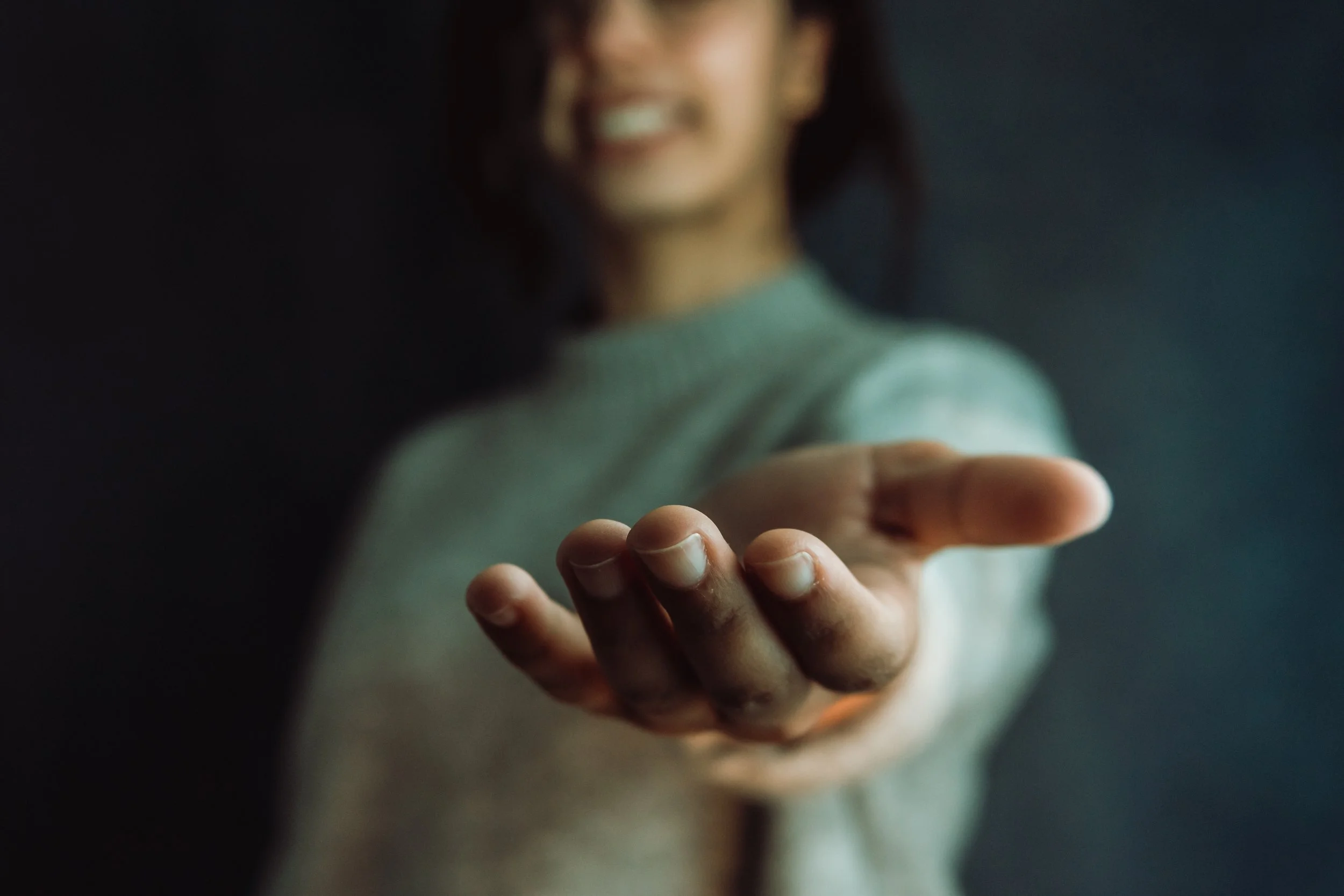 Client reaching out, showing trust and vulnerability in therapy session.