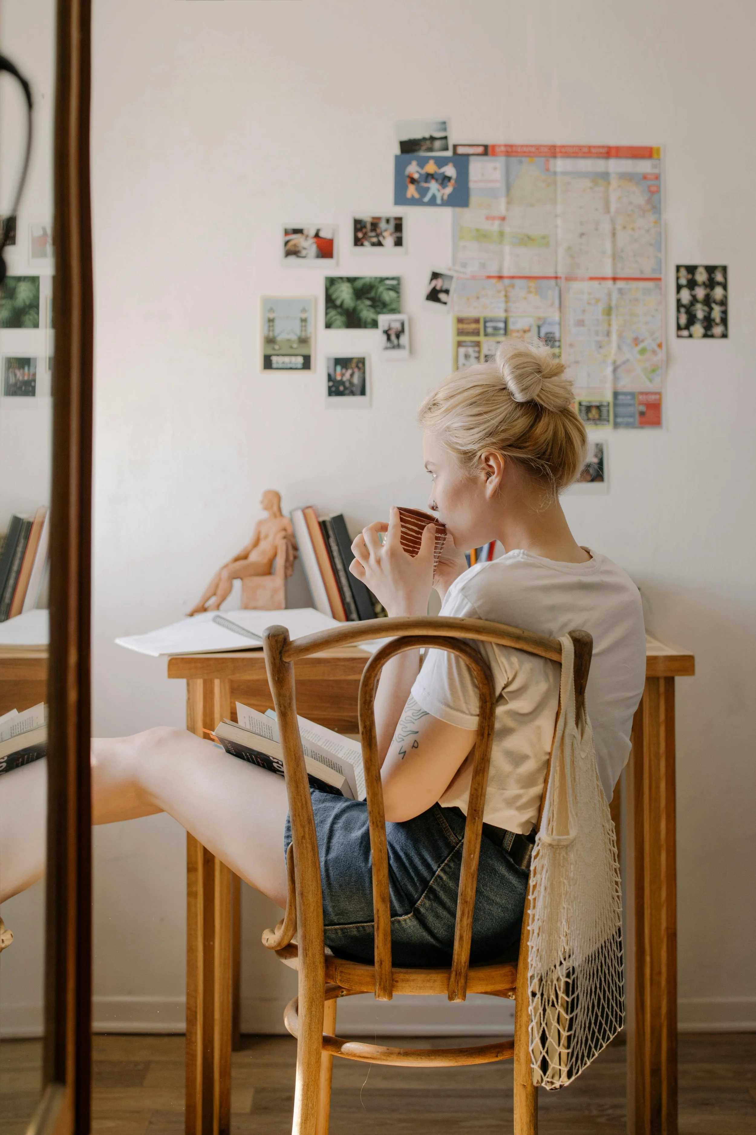 Woman sipping coffee at a desk in Madison, WI in a peaceful moment supporting self-care and emotional healing