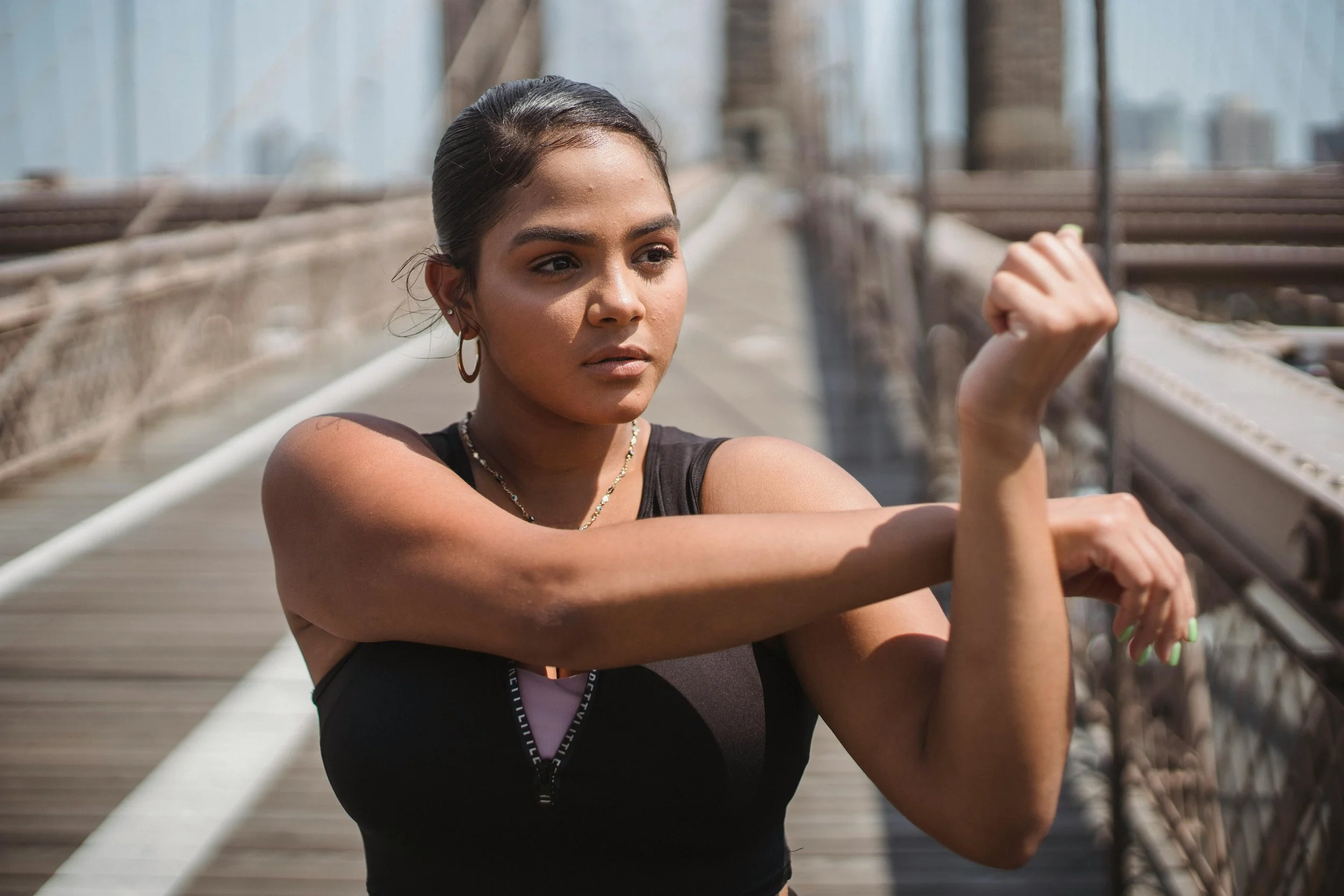 Woman engaging in gentle outdoor stretching to support body-based healing after domestic violence