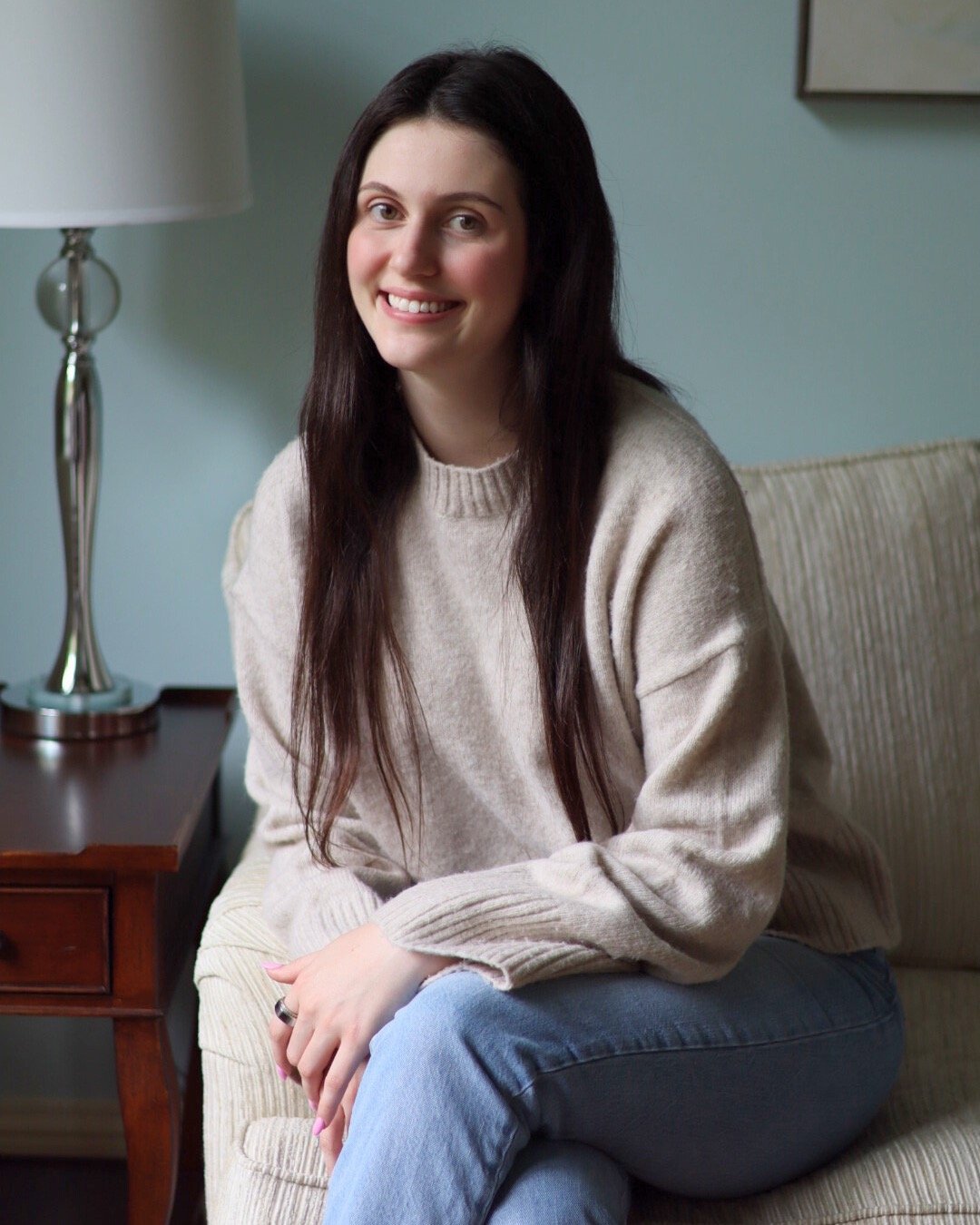 Licensed trauma therapist in office setting ready to support clients with PTSD and anxiety.