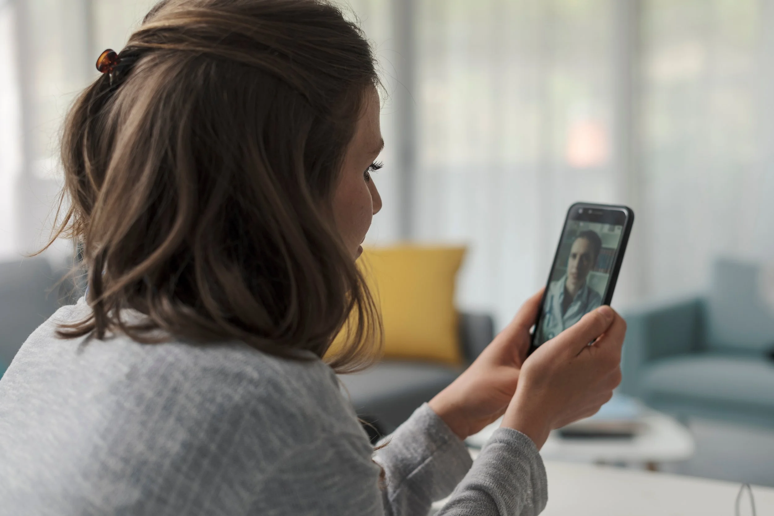 Person participating in online therapy to build trust and strengthen relationships.