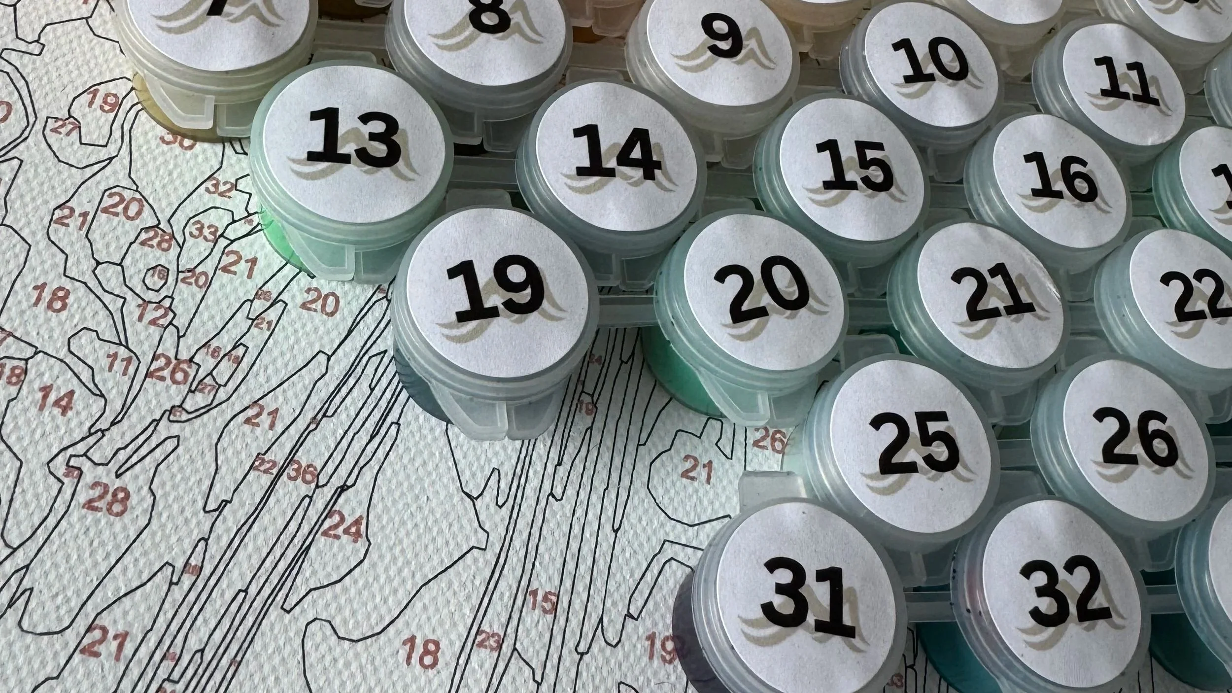 Paint pots on a numbered canvas