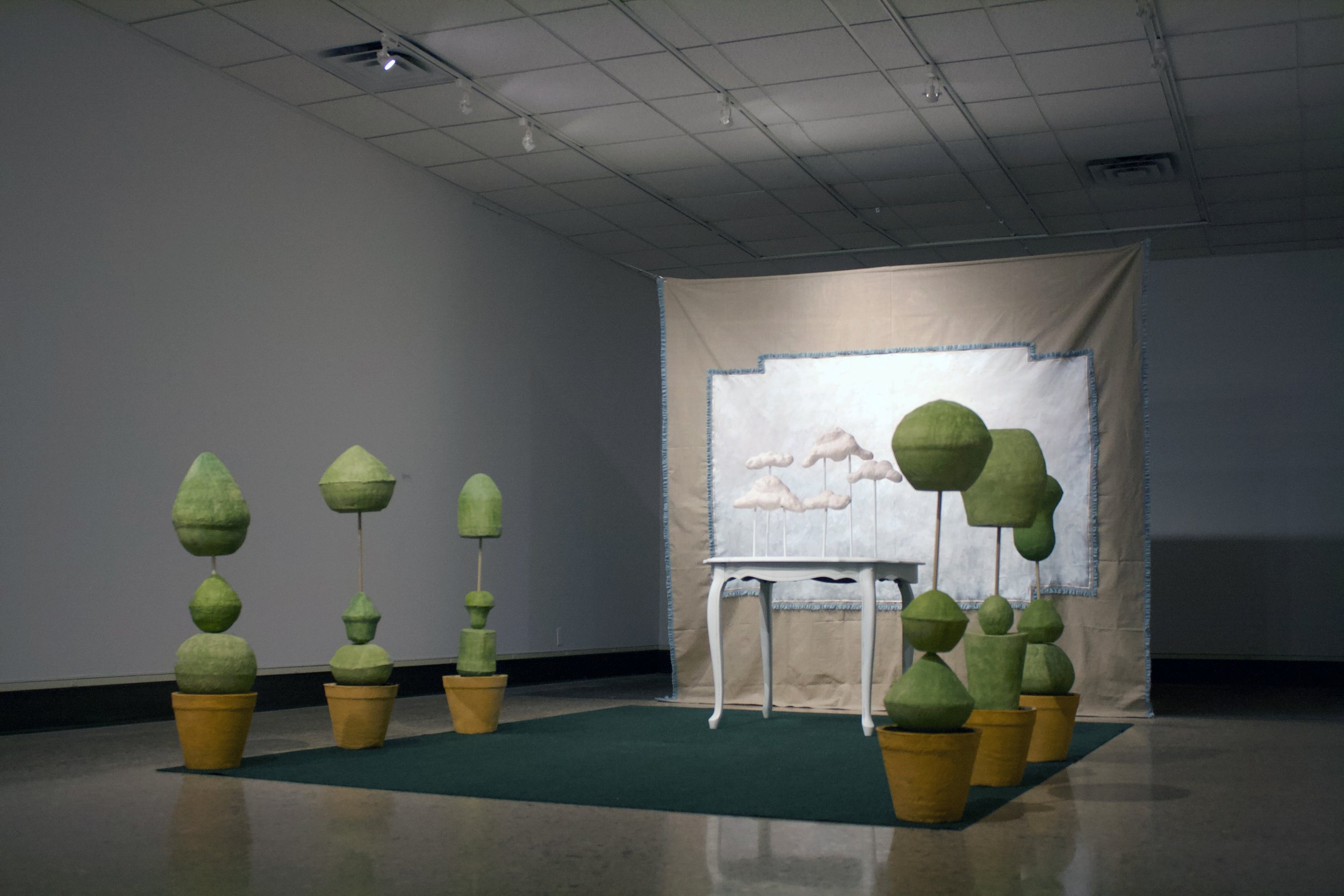 Without Worry, installation, variable size white earthenware, wood, paint, spray paint, beads, canvas, lace, paper, found table, rug and other miscellaneous materials, 2021