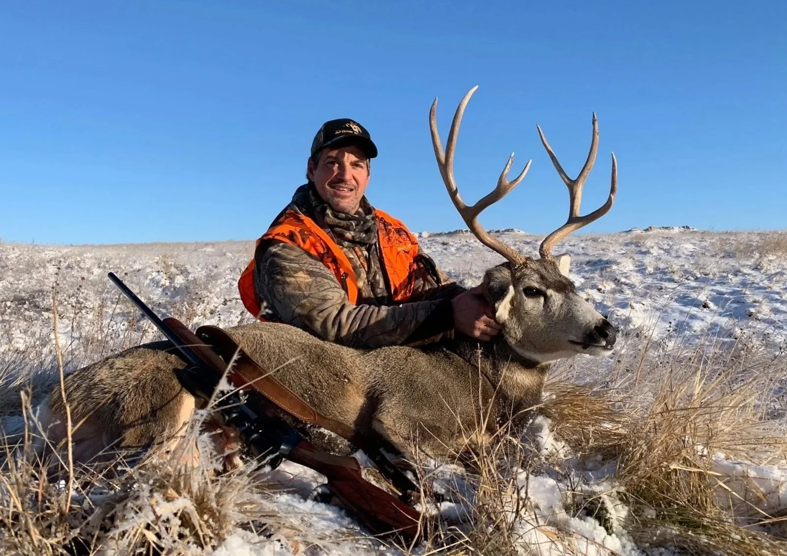 Hunting for deer in snow in central Montana with rifle and bow at Old Sage Outfitters.