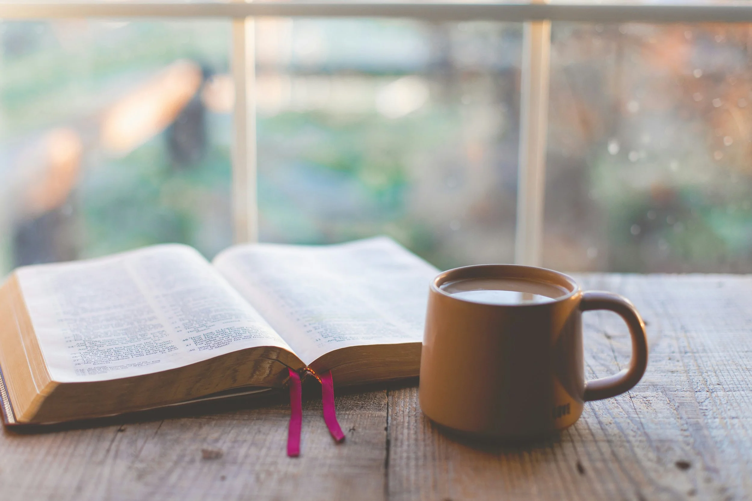 bible and cup of coffee by the window