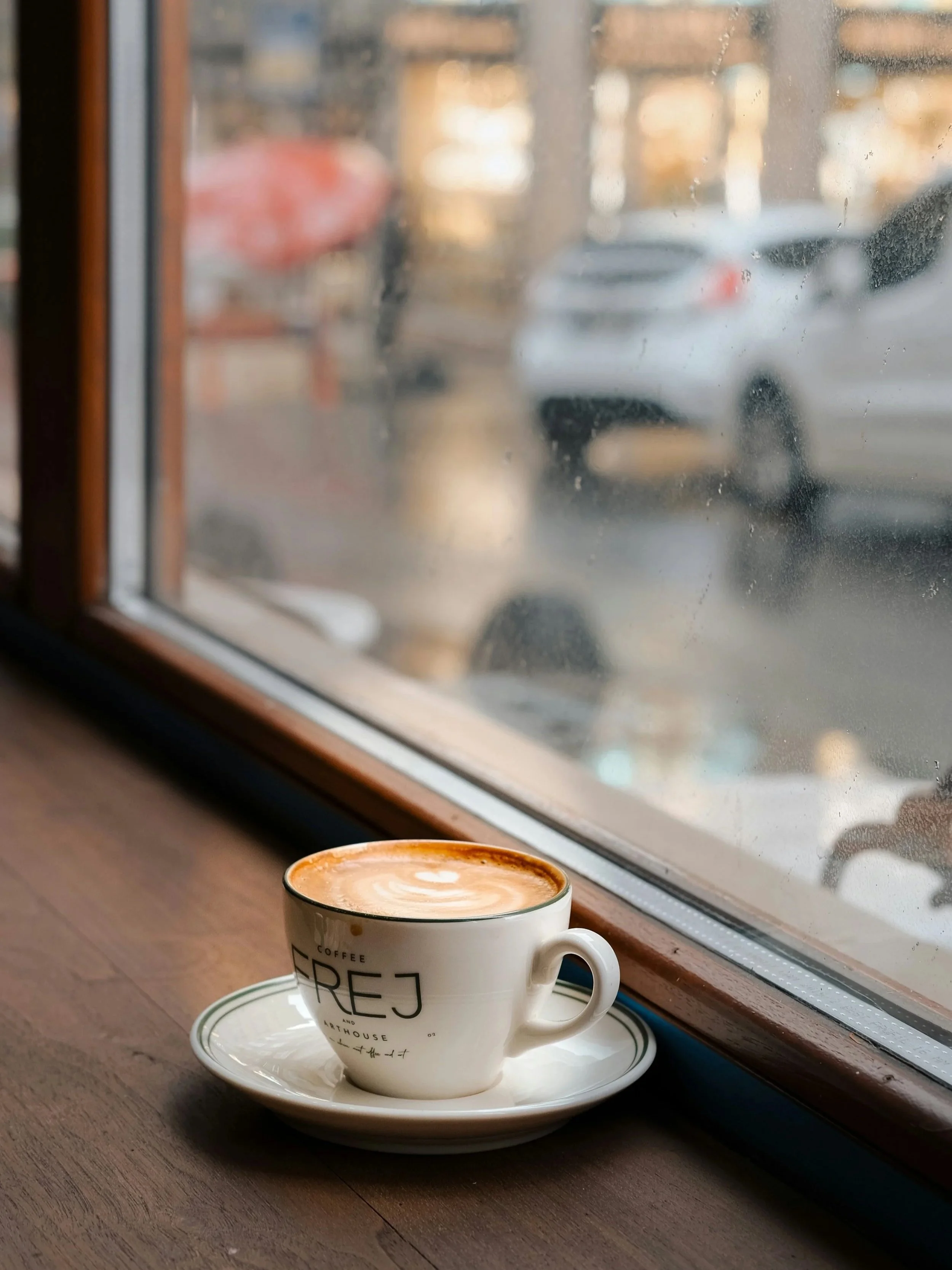 coffee cup in front of a window