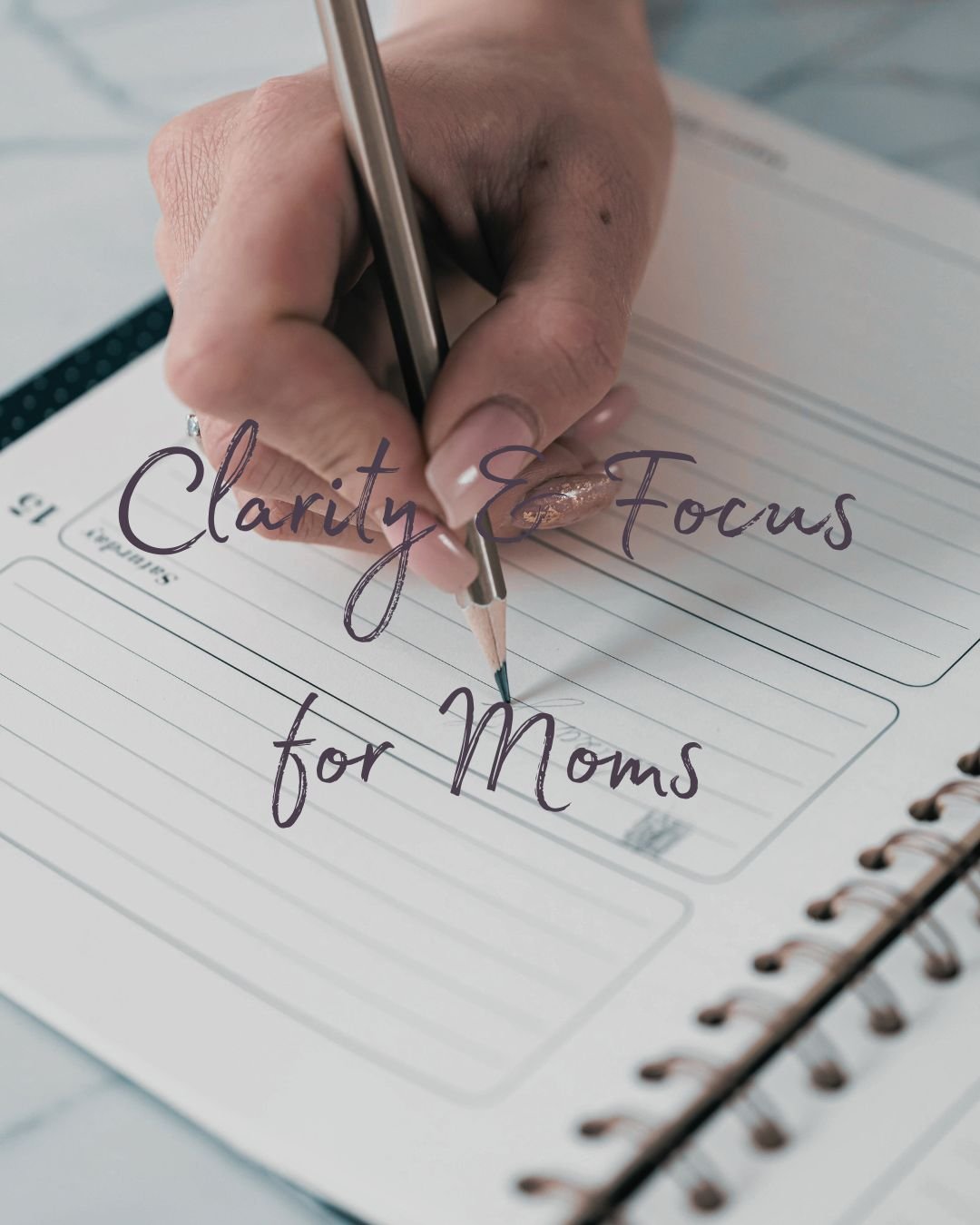 Hand writing on a planner page, with words Clarity & Focus for Moms