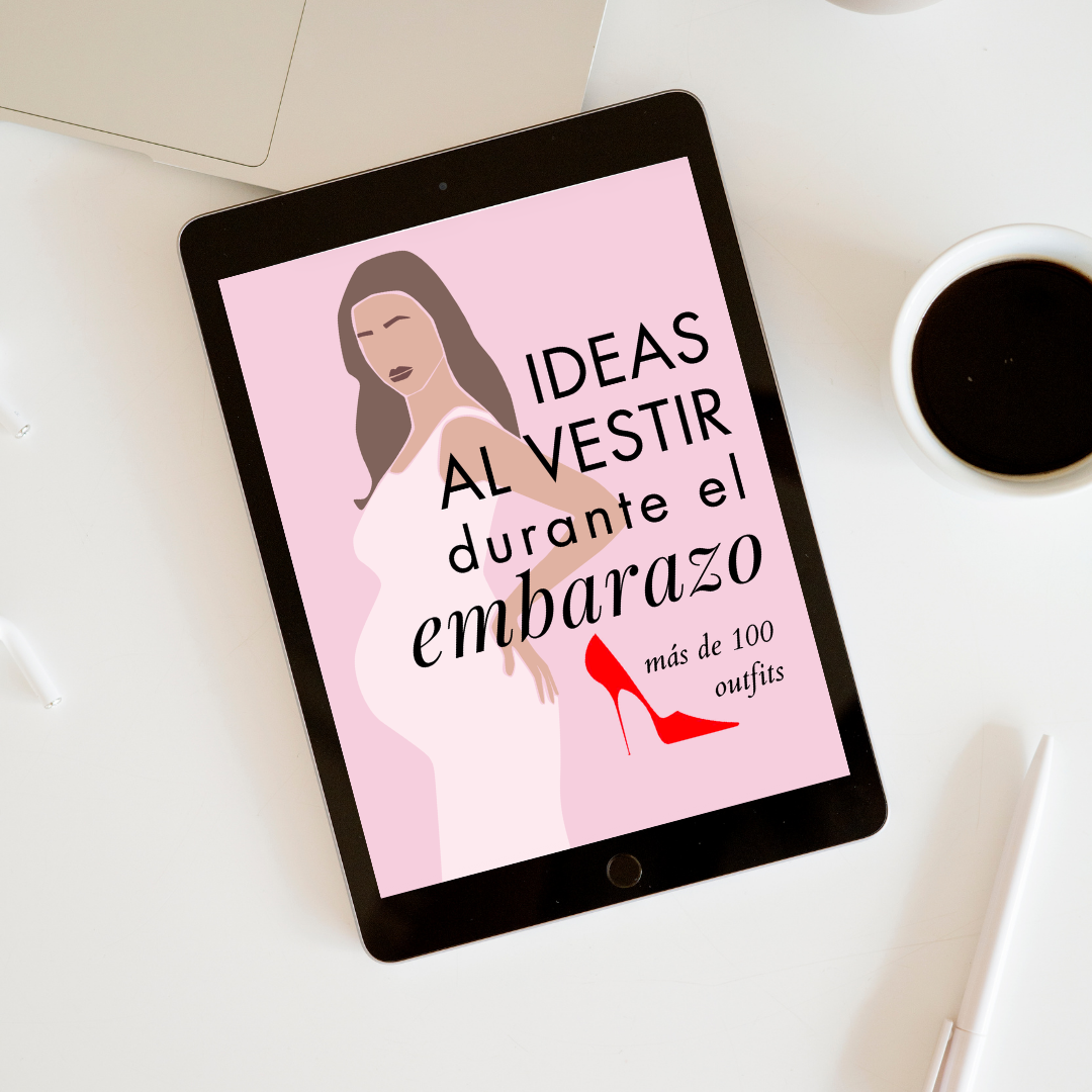 Pantalla de una tablet que muestra un dibujo de una mujer embarazada y el texto 'Ideas al vestir durante el embarazo más de 100 outfits' en letras negras y cursivas, con un zapato de tacón rojo.