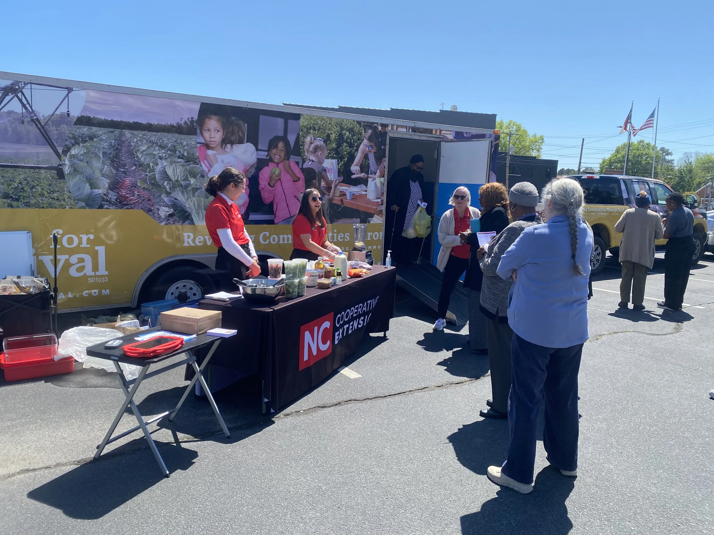 Project staff leading a cooking demonstration for mobile market patrons