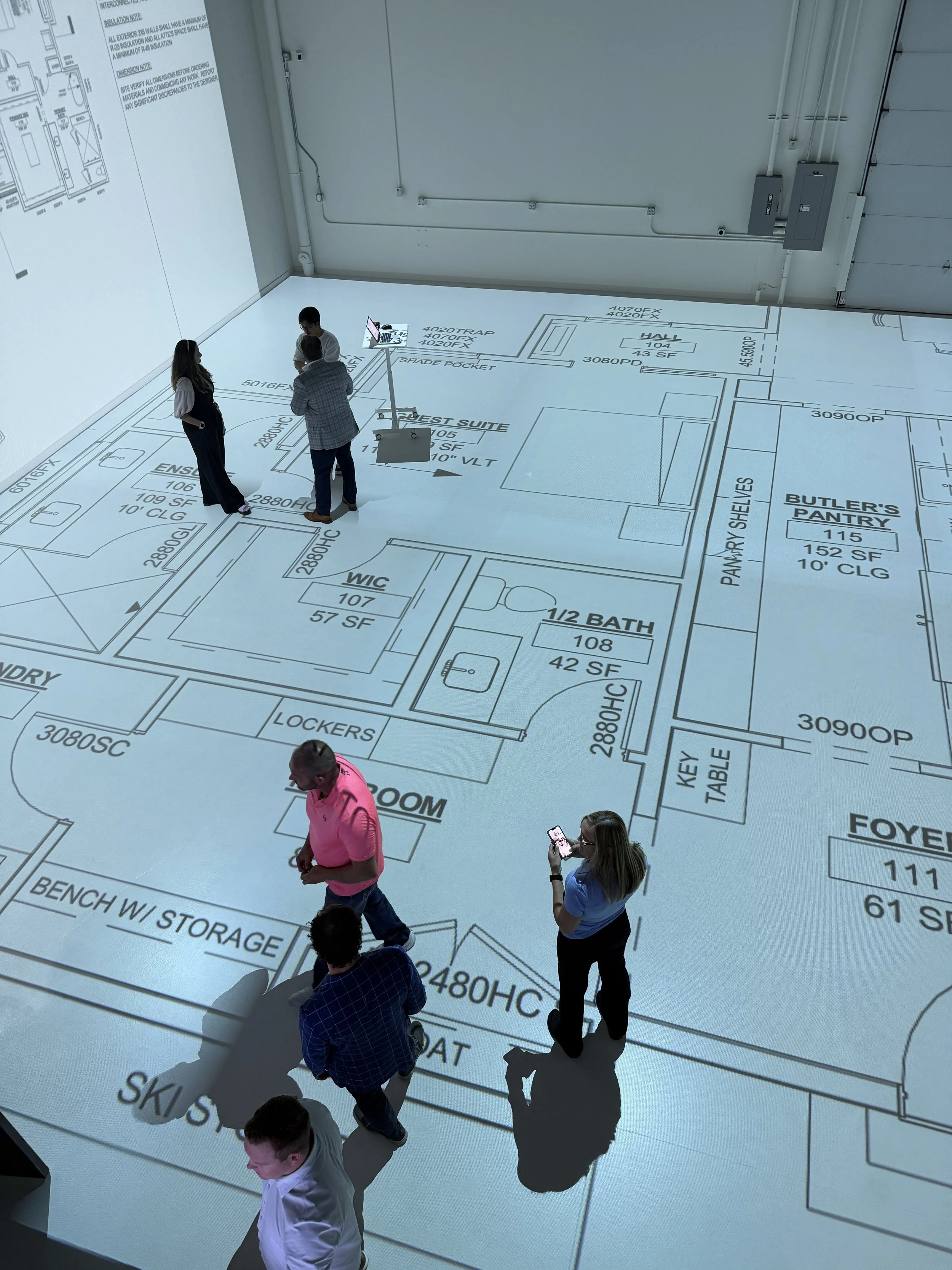 Design team walking plans at full scale