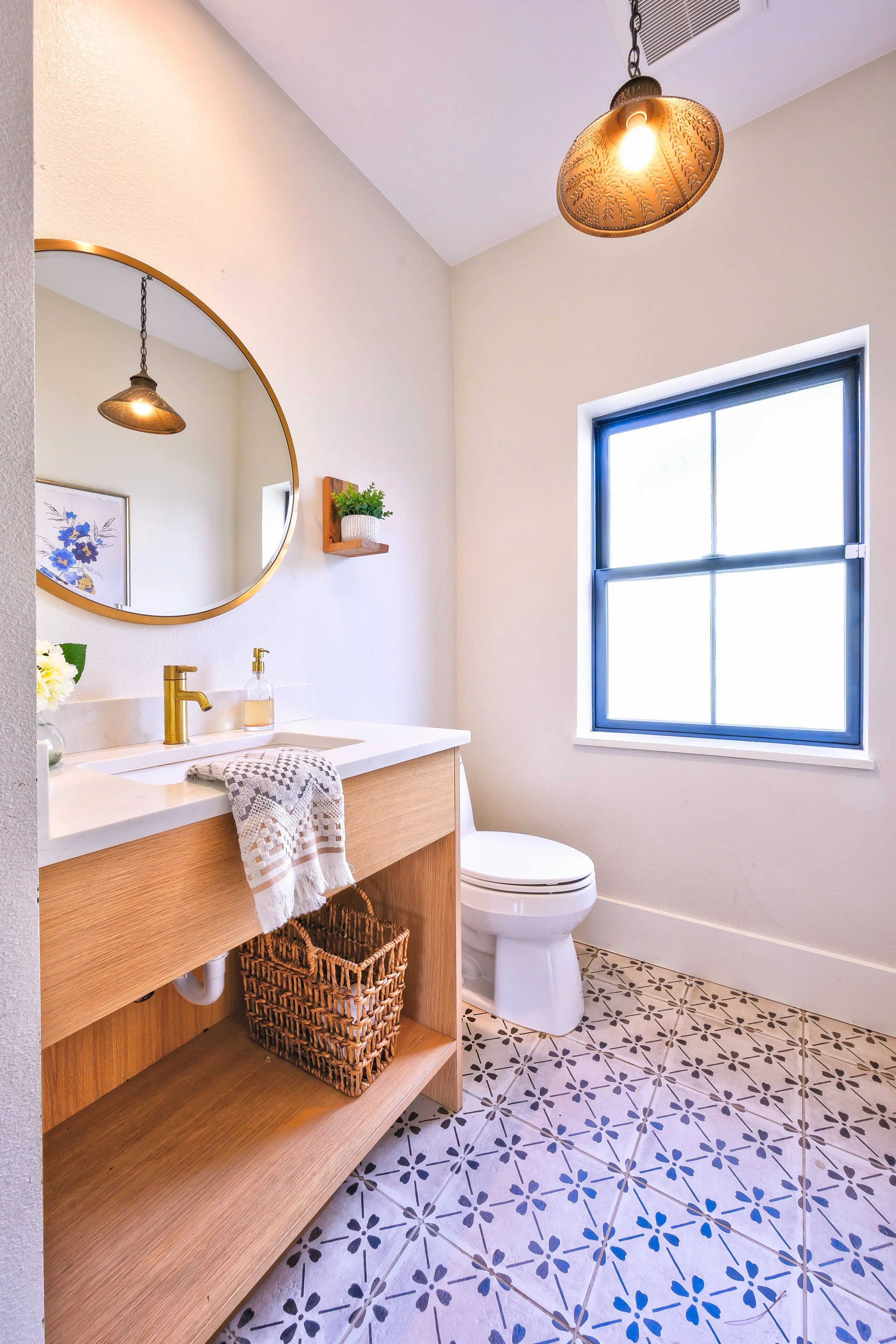 Vintage modern powder bath with white oak custom designed vanity, statement flooring, and satin brass finishes.