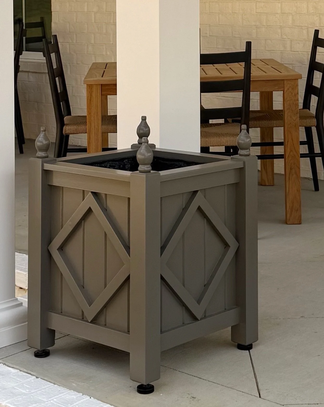 Four custom planters set and ready to be planted up for Spring. The dark paint color looks great against the white painted brick. Loved working with the gals @themixinteriors