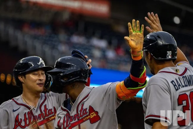 Ronald Acuña Jr. celebrates with Atlanta Braves teammates at Nationals Park.