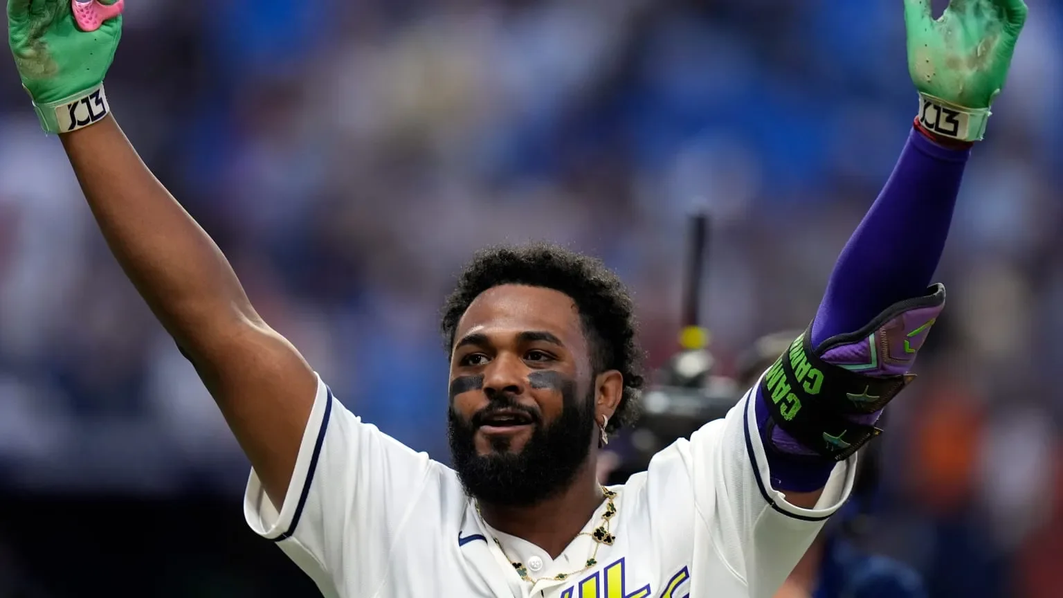 Junior Caminero raises his arms after a game-winning home run for Tampa Bay
