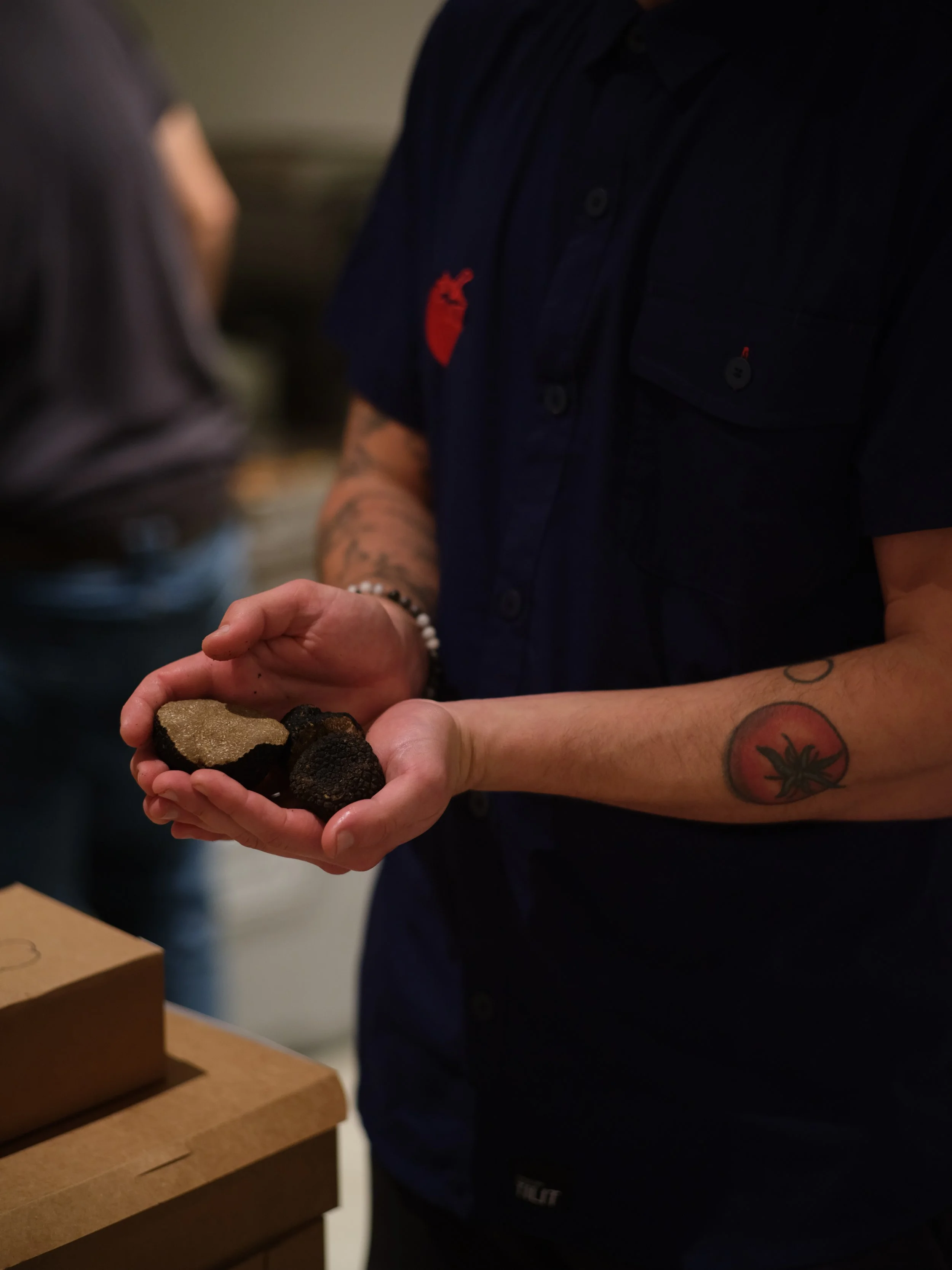 Chef holding fresh truffles at a Night Inn private cooking class in NYC