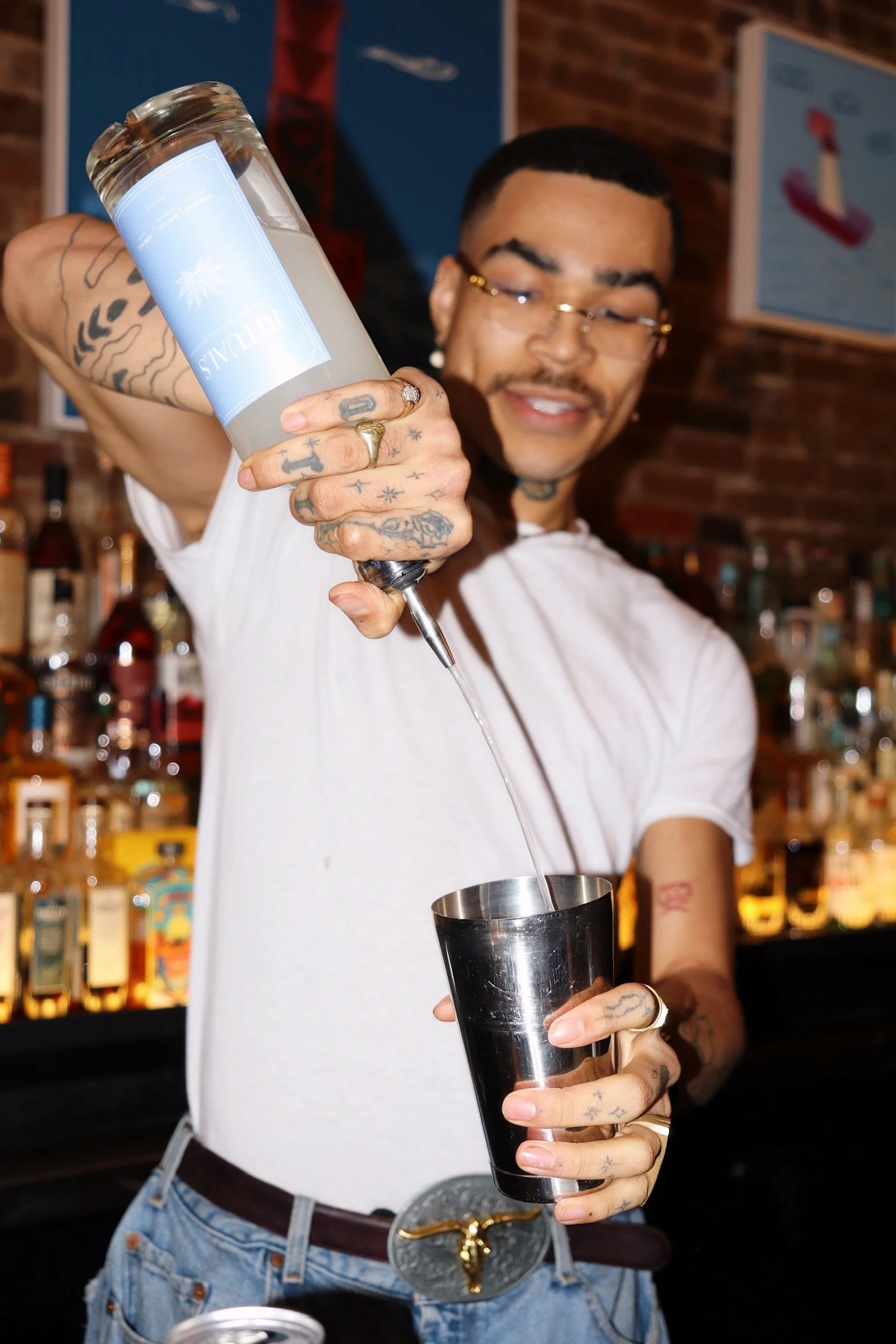 Mixologist pouring a cocktail during a Night Inn mixology class in NYC