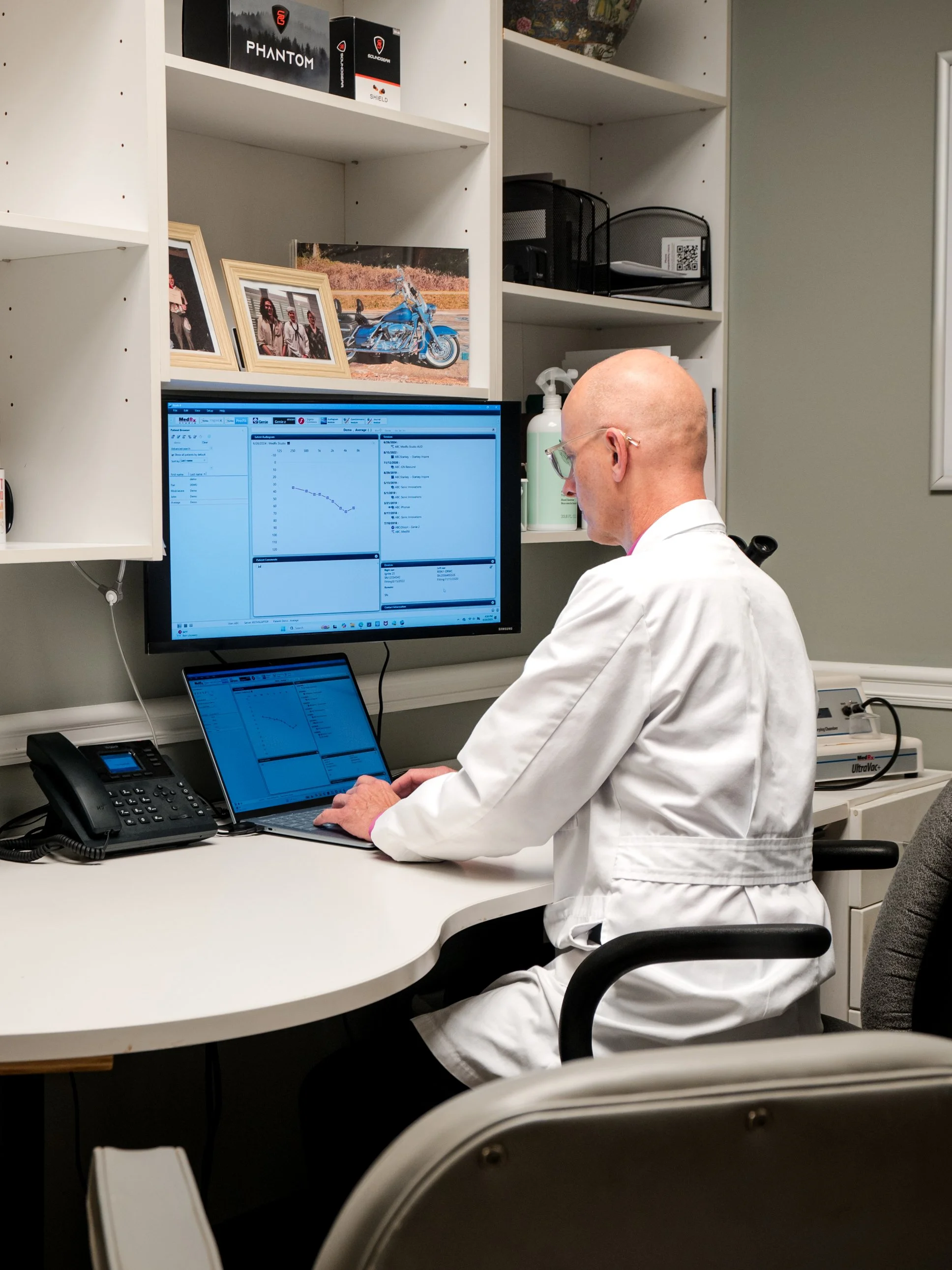 A woman receiving a hearing test from a healthcare professional in a medical office.